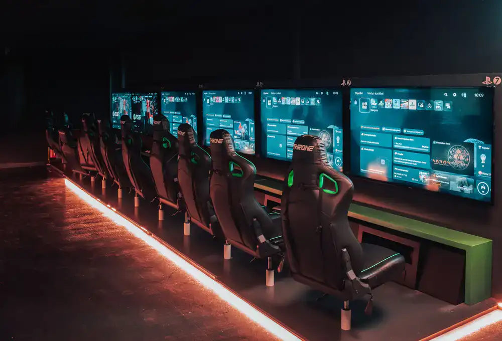 Wide shot of an esports main stage with player booths and LED screens