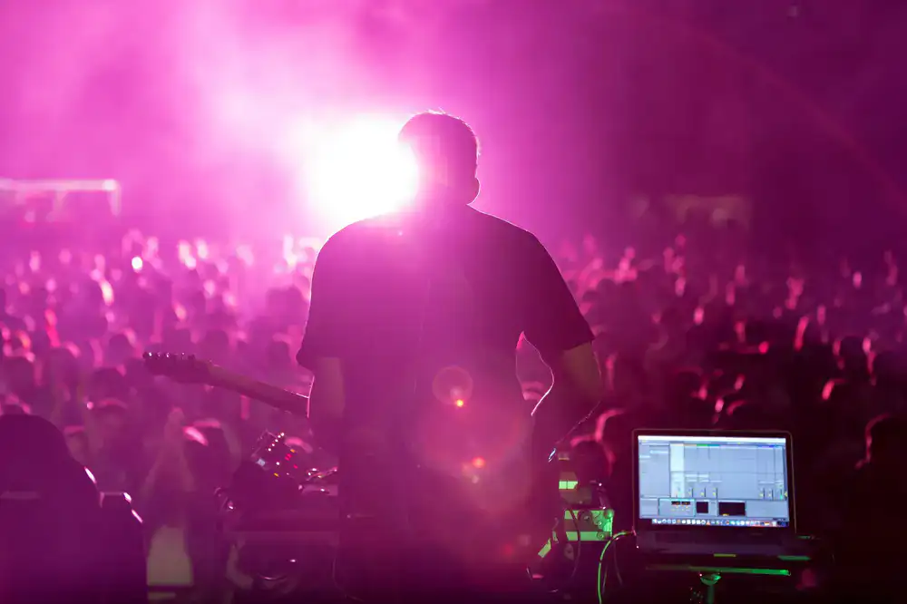 Massive esports main stage with electric blue and magenta lighting